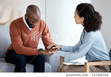 Black man, depression and psychologist support, empathy and holding hands for patient mental health. Counseling, psychology and USA therapy, therapist woman consulting client depressed, sad or crying Black man, depression and psychologist support, empathy and holding hands for patient mental health. Counseling, psychology and USA therapy, therapist woman consulting client depressed, sad or crying 131808108