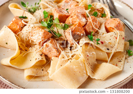 tagliatelli pasta, with salmon slices and herbs, on a decorative plate, homemade, no people 131808200