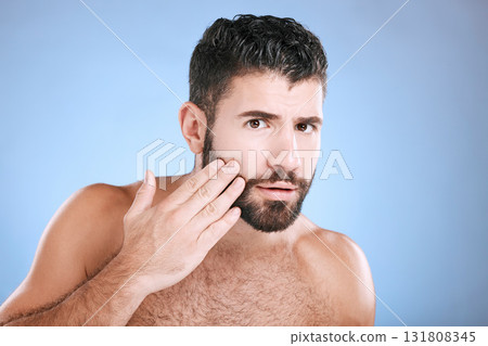 Skincare, beard grooming and portrait of man on blue background for beauty, wellness and salon. Luxury spa, dermatology and worried male check face for healthy skin, blackhead and facial hair growth 131808345
