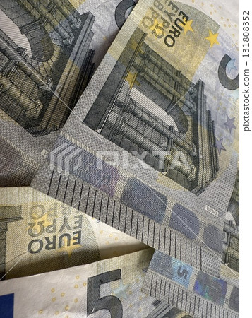 Macro photography of euro currency, highlighting financial themes such as pensions, taxes, income, and losses. Money, economics, and financial literacy. 131808352