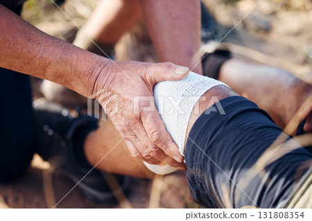 Sport bandage, first aid and hands of medical support for knee pain of elderly man hiking in mountain. Exercise, fitness and paramedic in nature with senior athlete hurt from sports accident outdoor Sport bandage, first aid and hands of medical support for knee pain of elderly man hiking in mountain. Exercise, fitness and paramedic in nature with senior athlete hurt from sports accident outdoor 131808354