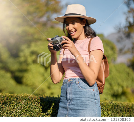 Photography, tourism and woman with a camera in nature for travel memory in Sweden. Summer, tourist and photographer looking at photos while traveling on a vacation in a park or botanical garden 131808365