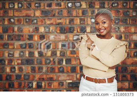 Pointing, mockup and portrait of black woman and brick wall background for announcement, product placement and offer. Idea, news and deal with female and gesture for information, opportunity and show Pointing, mockup and portrait of black woman and brick wall background for announcement, product placement and offer. Idea, news and deal with female and gesture for information, opportunity and show 131808373