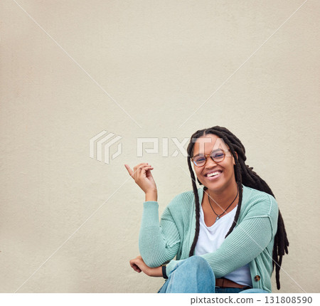 Black woman, portrait and hands pointing to mockup, advertising or empty background, laugh and excited. Hand gesture, face and girl relax in studio while showing wall copy space or isolated marketing Black woman, portrait and hands pointing to mockup, advertising or empty background, laugh and excited. Hand gesture, face and girl relax in studio while showing wall copy space or isolated marketing 131808590