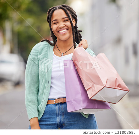 Fashion, portrait or happy black woman shopping with a smile walking on city street in retail therapy. Freedom, relax or African gen z girl with clothes, gift or products on discounted sales offer Fashion, portrait or happy black woman shopping with a smile walking on city street in retail therapy. Freedom, relax or African gen z girl with clothes, gift or products on discounted sales offer 131808683
