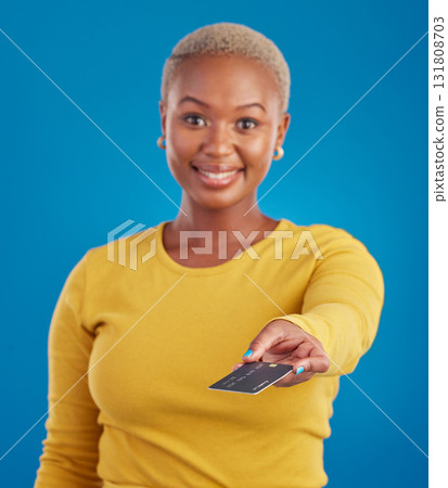 Credit card, payment and woman portrait in a studio with a smile from paying with happiness. Isolated, blue background and ecommerce with a young female model hand showing financial banking method Credit card, payment and woman portrait in a studio with a smile from paying with happiness. Isolated, blue background and ecommerce with a young female model hand showing financial banking method 131808703