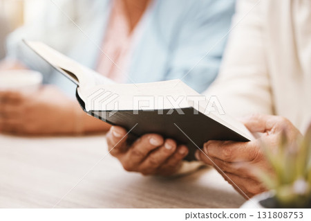 Book, faith and hands of couple with bible for spiritual studying or reading in home. Religion, worship and man and woman with holy and religious text for learning, education and worshipping God. Book, faith and hands of couple with bible for spiritual studying or reading in home. Religion, worship and man and woman with holy and religious text for learning, education and worshipping God. 131808753