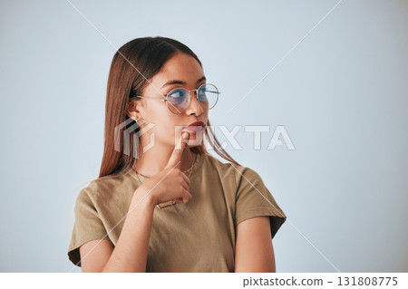 Woman, thinking and space for idea with glasses in studio for advertising or product placement mockup. Female with hand on chin for doubt or planning logo or branding decision on a white background 131808775