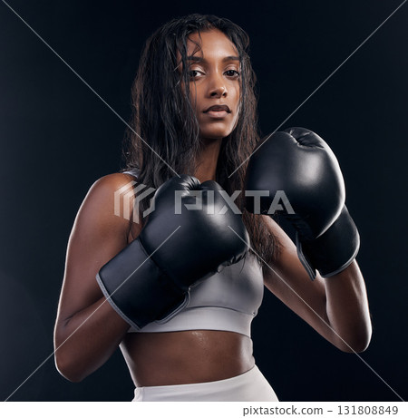 Boxer, fight and portrait of woman on black background for sports, strong focus or mma training. Female boxing, workout or fist gloves of impact, energy and warrior power for studio fitness challenge Boxer, fight and portrait of woman on black background for sports, strong focus or mma training. Female boxing, workout or fist gloves of impact, energy and warrior power for studio fitness challenge 131808849