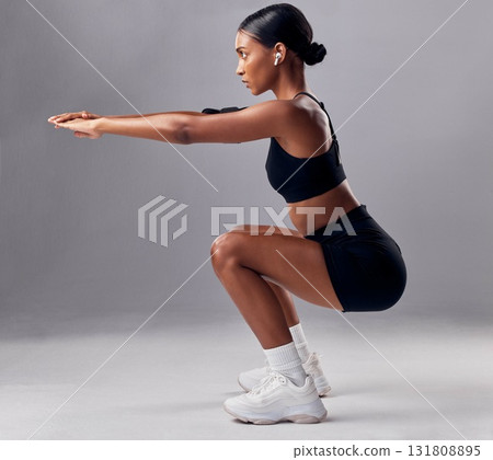 Exercise, black woman and squat for training, workout and fitness for health, wellness and grey studio background. Female, lady and athlete bending, stretching and practice for endurance and energy 131808895