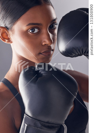 Boxing hands, gloves and portrait of woman in studio for sports, strong muscle or mma exercise. Female boxer, workout and fist fight of warrior, energy or fitness power in battle, challenge or action 131808900