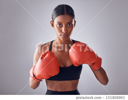 Boxing, fitness and portrait of woman in studio for sports exercise, strong muscle or mma training. Indian female, boxer champion and gloves for impact, energy and warrior power in battle challenge 131808901