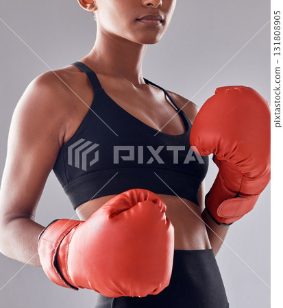 Boxing, fitness gloves and woman in studio for sports exercise, strong muscle or mma training. Female boxer, workout and fist fight for impact, energy and warrior power in battle, challenge or action 131808905