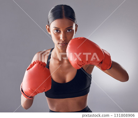 Boxer, fight and portrait of woman in studio for sports exercise, strong muscle or mma training. Indian female, boxing workout and fist gloves for impact, energy and warrior power in battle challenge 131808906