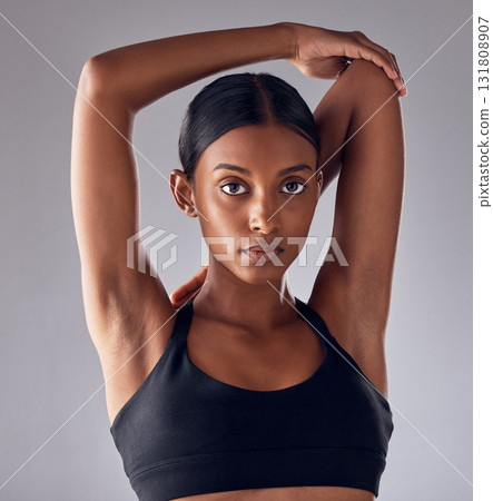 Exercise, face portrait and woman stretching for cardio fitness running, marathon training or body healthcare goals. Performance workout, studio health or athlete warm up isolated on grey background 131808907