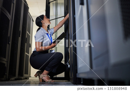 Server room, engineer and woman with tablet for database connection cable, maintenance or software update at night. Cybersecurity, it and female coder with technology for networking in data center. Server room, engineer and woman with tablet for database connection cable, maintenance or software update at night. Cybersecurity, it and female coder with technology for networking in data center. 131808948