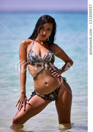 Sexy girl posing in the sunny day at the tropical beach Sexy girl posing in the sunny day at the tropical beach 131808957
