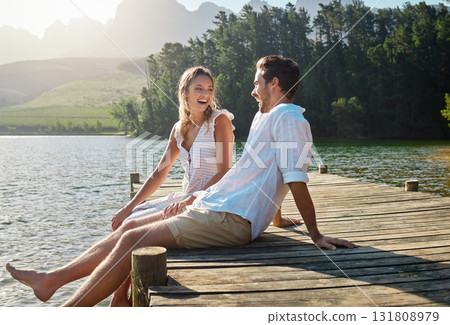 Love, laugh and pier with couple at lake for bonding, romance and affectionate date. Nature, travel and holiday with man and woman sitting on boardwalk in countryside for happy, summer and vacation Love, laugh and pier with couple at lake for bonding, romance and affectionate date. Nature, travel and holiday with man and woman sitting on boardwalk in countryside for happy, summer and vacation 131808979