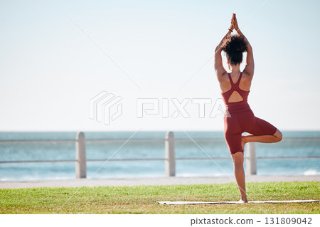 Fitness, black woman and yoga meditation by beach for spiritual wellness or exercise in nature. Female yogi back standing and stretching on mat in balance zen workout, relax or meditating on mockup Fitness, black woman and yoga meditation by beach for spiritual wellness or exercise in nature. Female yogi back standing and stretching on mat in balance zen workout, relax or meditating on mockup 131809042