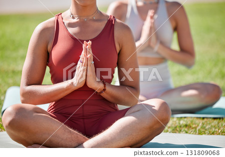 Yoga, class and praying hands of women for zen fitness, exercise and mindfulness, healing and peace in park grass. Meditation, spiritual and calm people, prayer or namaste for body wellness together 131809068