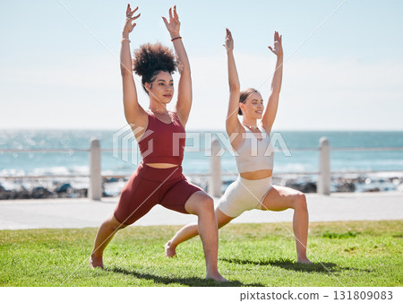 Yoga, fitness and beach with woman friends outdoor together in nature for wellness training. Exercise, chakra or zen with a female yogi and friend outside for a mental health workout by the ocean 131809083