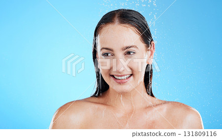 Water, shower and happy woman washing in studio for skincare, wellness and clean body for self care. Face of female model, splash or drop for cleaning, hygiene and cosmetics on blue background mockup 131809116