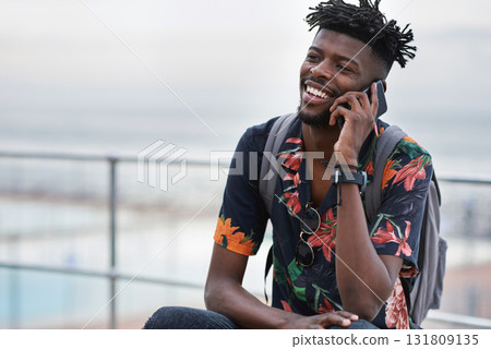 Phone call, communication and black man with a cellphone in the city while on an adventure. Happy, smile and African male on a mobile conversation with smartphone in town on a holiday or weekend trip Phone call, communication and black man with a cellphone in the city while on an adventure. Happy, smile and African male on a mobile conversation with smartphone in town on a holiday or weekend trip 131809135