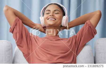Relax, headphones and woman on a living room sofa feeling peace from music. Web radio, home and podcast of a young female with a smile from zen and stress relief audio on a lounge couch in a house Relax, headphones and woman on a living room sofa feeling peace from music. Web radio, home and podcast of a young female with a smile from zen and stress relief audio on a lounge couch in a house 131809273