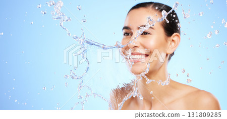 Water splash, smile or happy girl with face wash for skincare or hygiene on blue background in studio. Banner, mockup or woman with wellness cleaning or washing in beauty grooming or facial treatment Water splash, smile or happy girl with face wash for skincare or hygiene on blue background in studio. Banner, mockup or woman with wellness cleaning or washing in beauty grooming or facial treatment 131809285