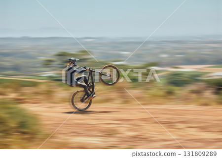Extreme sports, bicycle and man cycling in the countryside for fitness, stunt and freedom. Nature, biking and sporty male cyclist training, practice and speed, action and free on Mexico dirt road Extreme sports, bicycle and man cycling in the countryside for fitness, stunt and freedom. Nature, biking and sporty male cyclist training, practice and speed, action and free on Mexico dirt road 131809289