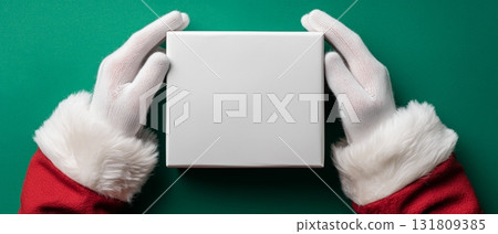 Hands in White Gloves Holding a Blank Gift Box During the Holiday Season 131809385