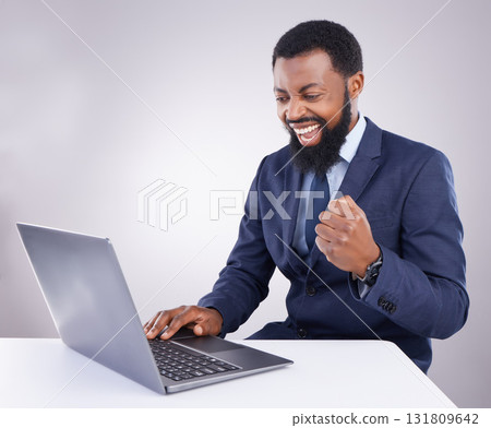 Winner black man on laptop isolated on a white background stock market, trading success or business bonus and fist pump. Yes, winning and person celebrate sales, profit or goals on computer in studio 131809642