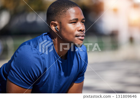 Fitness, break and man runner relax with music before training, running or morning cardio outdoors. Sports, pause and male athlete breathing, mindset and preparation for marathon practice workout run 131809646
