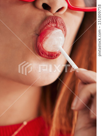 Lollipop, woman mouth and closeup with makeup, cosmetics and gen z style eating a sweet candy. Lips, young person and hungry female model with sweets and modern fashion and youth aesthetic close up Lollipop, woman mouth and closeup with makeup, cosmetics and gen z style eating a sweet candy. Lips, young person and hungry female model with sweets and modern fashion and youth aesthetic close up 131809758