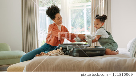 Mother, child and packing suitcase in home bedroom together for travel trip and ready for family vacation. Happy African woman or parent with girl kid on hotel bed with clothes or luggage for holiday Mother, child and packing suitcase in home bedroom together for travel trip and ready for family vacation. Happy African woman or parent with girl kid on hotel bed with clothes or luggage for holiday 131810069