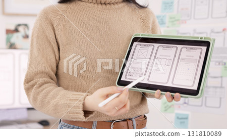 Tablet, ux design presentation and woman developer with ideas, plan and sketch at workshop. Tech, digital display blueprint and web designer showing future ui system on mobile app for pitch meeting. Tablet, ux design presentation and woman developer with ideas, plan and sketch at workshop. Tech, digital display blueprint and web designer showing future ui system on mobile app for pitch meeting. 131810089