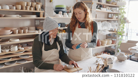Pottery, art and teacher with student in a workshop for learning with clay sculpting or molding. Creative, teaching and artist manufacturing a mud ceramic design product with mentor in a studio. 131810122