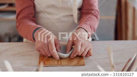 Bowl, hands of artist and pottery closeup in studio, workshop craft and small business of creative manufacturing. Ceramic designer, clay artisan and sculpture in class, mud mold and handmade process 131810127