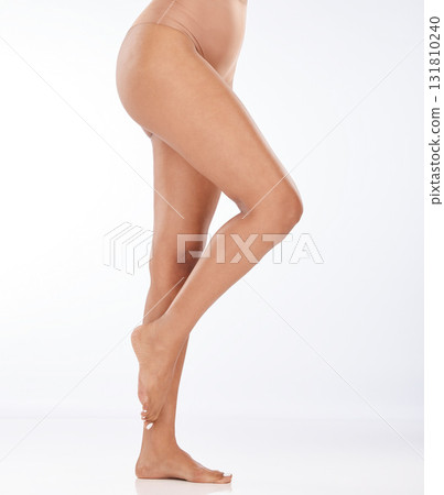 Legs, skin and black woman with epilation and skincare, laser hair removal with waxing on studio background. Cosmetics, beauty and glow with feet, pedicure and spa treatment with mockup space 131810240