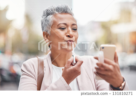 Woman, phone and lipstick in city for makeup, happy or cosmetics for financial service career. Accountant, cosmetic and face beauty by blurred background in metro, summer and smartphone for aesthetic 131810271