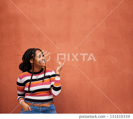 Mockup, pointing or black woman with marketing, product placement or branding space on wall background. Smile or African gen z girl advertising discount deal, sales offer or promotion announcement 131810339