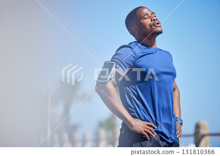 Fitness, exercise and tired man runner outdoors for break from training, cardio or running on blue sky background. Workout, stop and breathe by athletic guy outside for marathon, run or sport routine Fitness, exercise and tired man runner outdoors for break from training, cardio or running on blue sky background. Workout, stop and breathe by athletic guy outside for marathon, run or sport routine 131810366