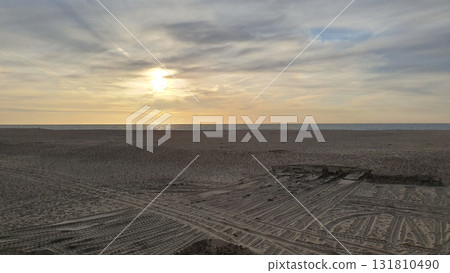 Sunset on the beach near beautiful sea in the evening. Yellow sunlight. Vacation in Ostend, Belgien. Sunset on the beach near beautiful sea in the evening. Yellow sunlight. Vacation in Ostend, Belgien. 131810490