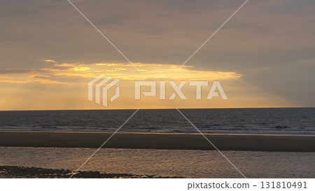 Sunset on the beach near beautiful sea in the evening. Yellow sunlight. Vacation in Ostend, Belgien. Sunset on the beach near beautiful sea in the evening. Yellow sunlight. Vacation in Ostend, Belgien. 131810491