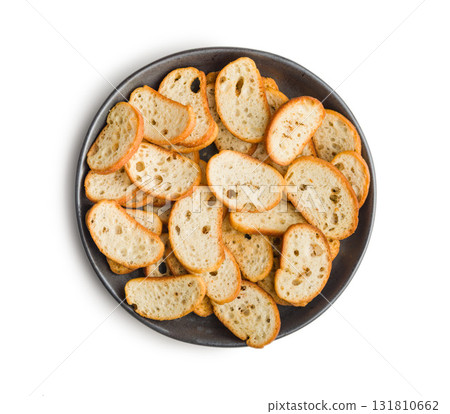 Crispy roasted bruschetta bread on plate  isolated on white background. 131810662