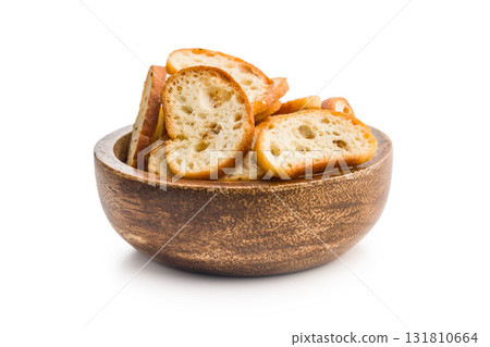 Crispy roasted bruschetta bread in bowl isolated on white background. Crispy roasted bruschetta bread in bowl isolated on white background. 131810664