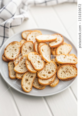 Crispy roasted bruschetta bread on plate on white table. 131810672