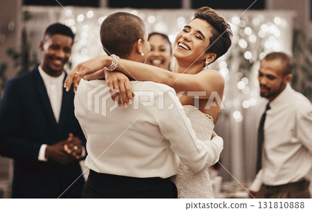 Wedding, diversity and dance with a lesbian couple in celebration of their union together at a ceremony of tradition. LGBT, woman or love with a female and partner dancing after being married Wedding, diversity and dance with a lesbian couple in celebration of their union together at a ceremony of tradition. LGBT, woman or love with a female and partner dancing after being married 131810888