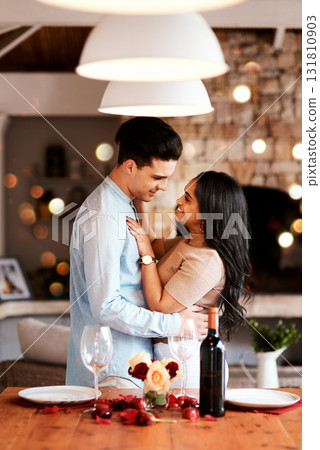 Love, smile and romance, couple hug on valentines day date at home with wine, rose petals and bokeh. Date night, man and woman in living room, valentine celebration and happy relationship together. Love, smile and romance, couple hug on valentines day date at home with wine, rose petals and bokeh. Date night, man and woman in living room, valentine celebration and happy relationship together. 131810903