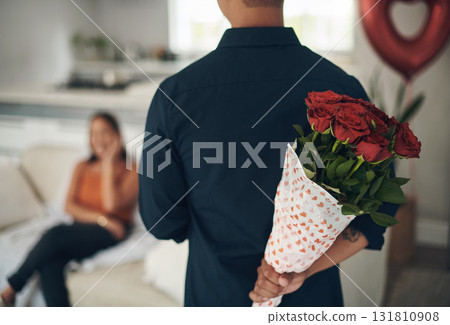 Man, hands and red roses behind back for valentines day surprise, gift or present to celebrate date at home. Hand of male with bouquet of flowers in celebration anniversary for special month of love Man, hands and red roses behind back for valentines day surprise, gift or present to celebrate date at home. Hand of male with bouquet of flowers in celebration anniversary for special month of love 131810908